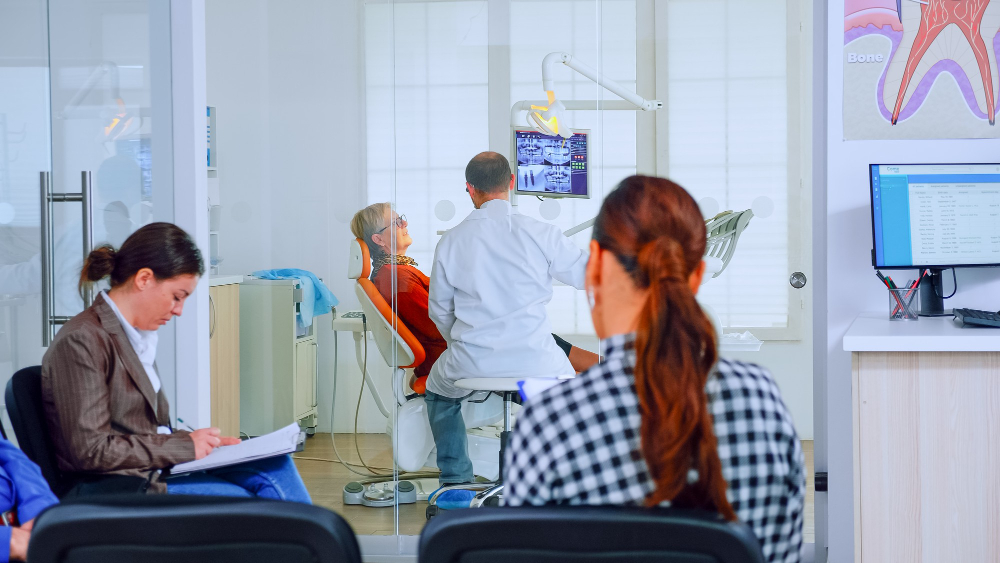 patients-sitting-chairs-waiting-room-stomatological-clinic-filling-stomatological-forms-while-doctor-working-background-concept-crowded-professional-orthodontist-reception-office (1)